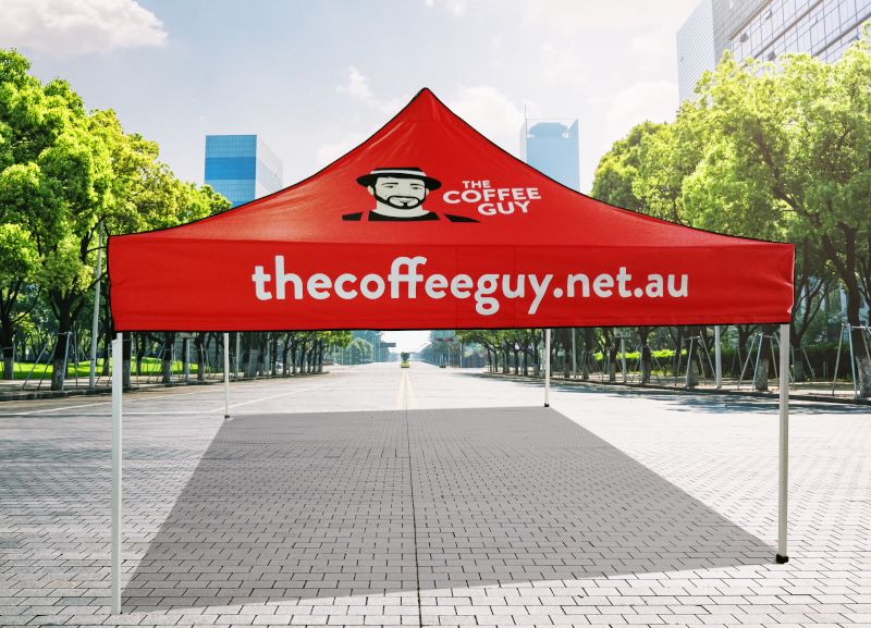 Red custom printed pop-up marquee with The Coffee Guy logo on the roof and web address on the valance
